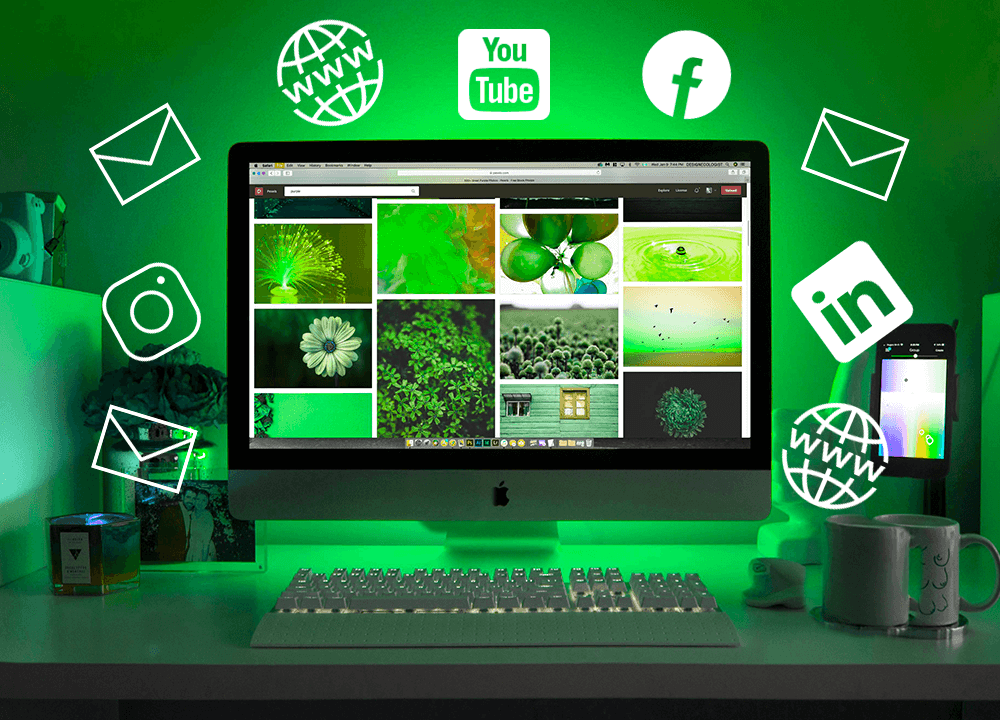 Computer with a green background and social media icons floating around it.